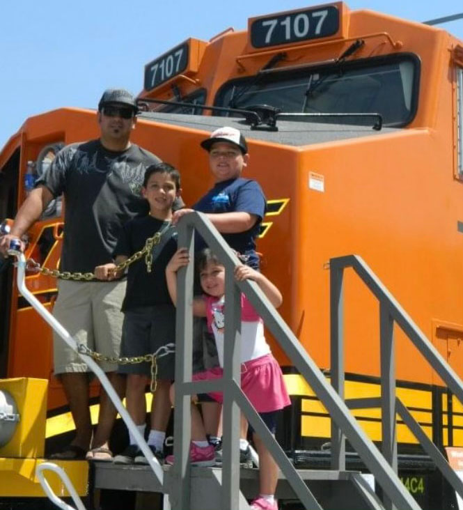 Chavez with his children in front of locomotive 7107