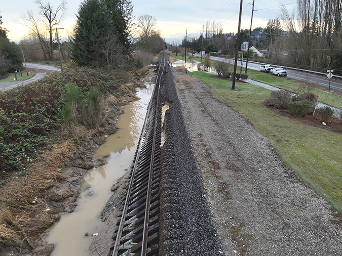Flooding caused a washout and ballast shoulder collapse of several hundred feet of track.